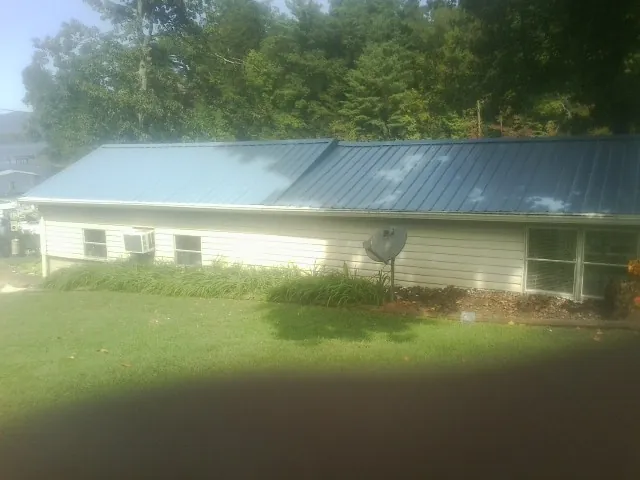 Blue metal roof running the length of a single story home in Wayland